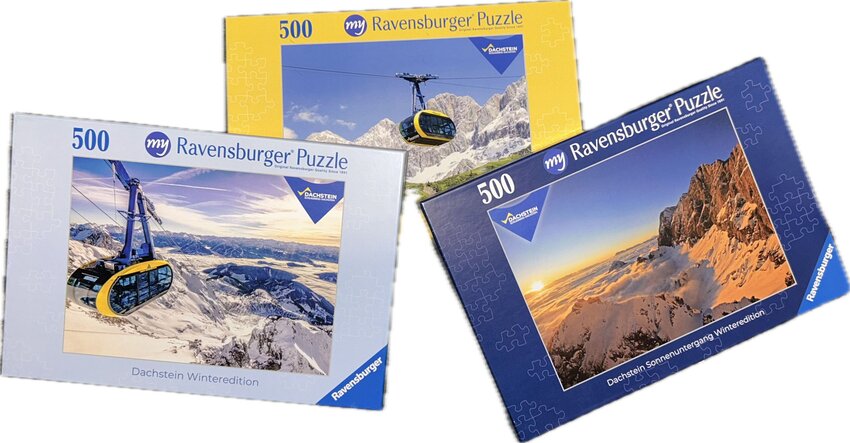 Drei Puzzle-Schachteln mit 500 Teilen von Ravensburger mit Motiven der Dachsteinbahn und Berglandschaft | © Planai-Hochwurzen-Bahnen Gesellschaft m.b.H.