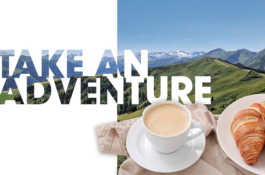 Tasse Kaffee mit zwei Croissants vor grünem Alpenpanorama und Text „Take an Adventure“ | © Großarler Bergbahnen GmbH & Co KG